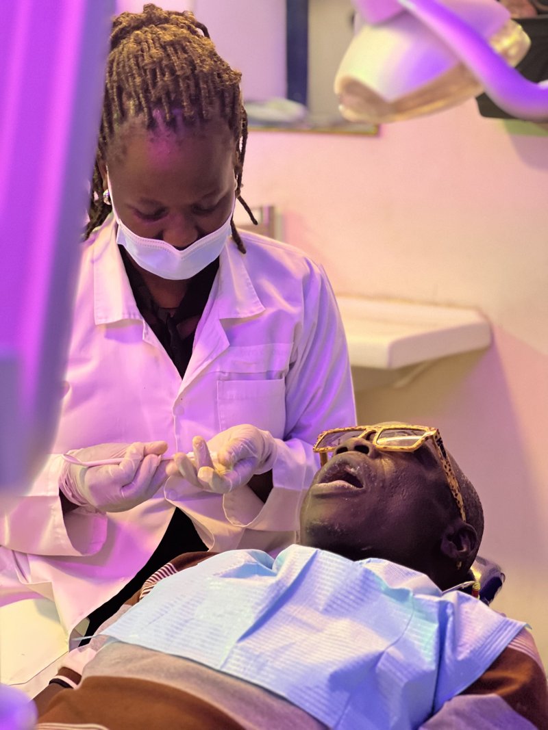 Piwan Dental clinician performing cosmetic treatment on a patient in Gulu