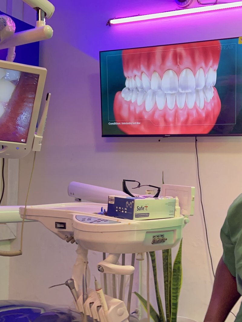 Dr. Okeny Geofrey with modern dental imaging equipment at Piwan Dental, Gulu, Uganda